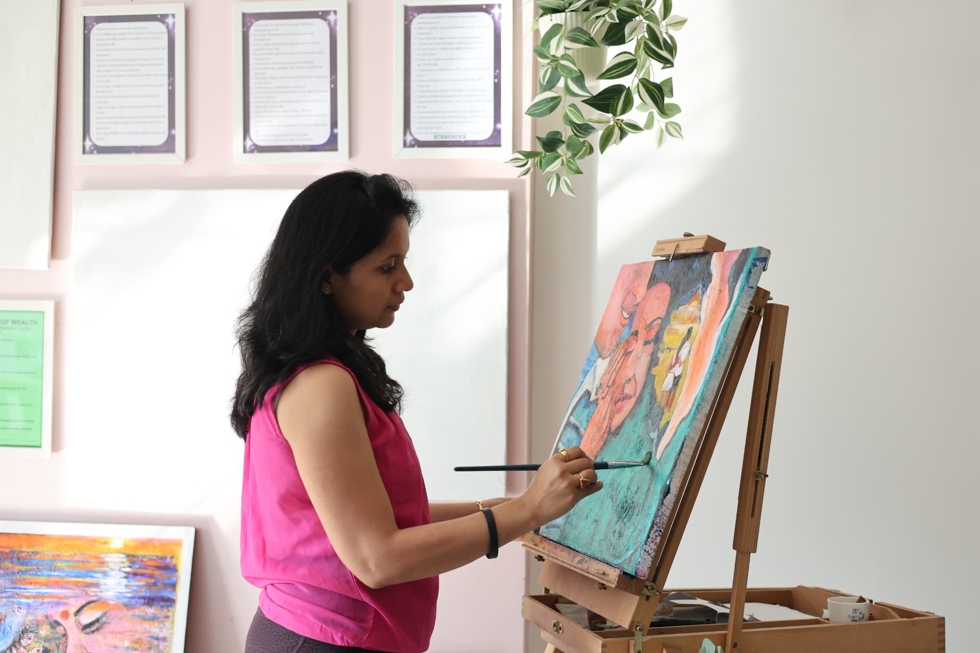 Jayita Dana painting a visionary portrait at her studio easel